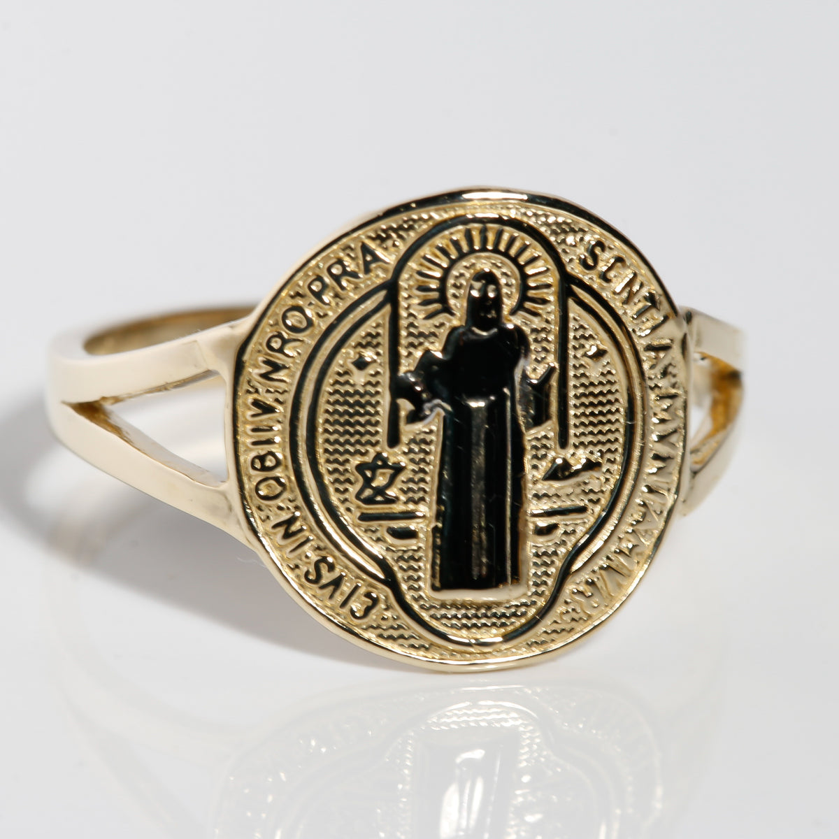 Angled view of two-tone 14K gold San Benito ring with white gold saint