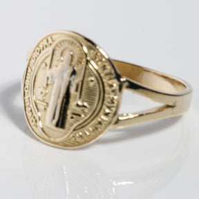 Angled view of two-tone 14K gold San Benito ring with white gold saint
