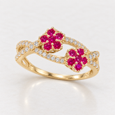 Front view of a 14K solid yellow gold floral bypass ring with fuchsia and clear cubic zirconias