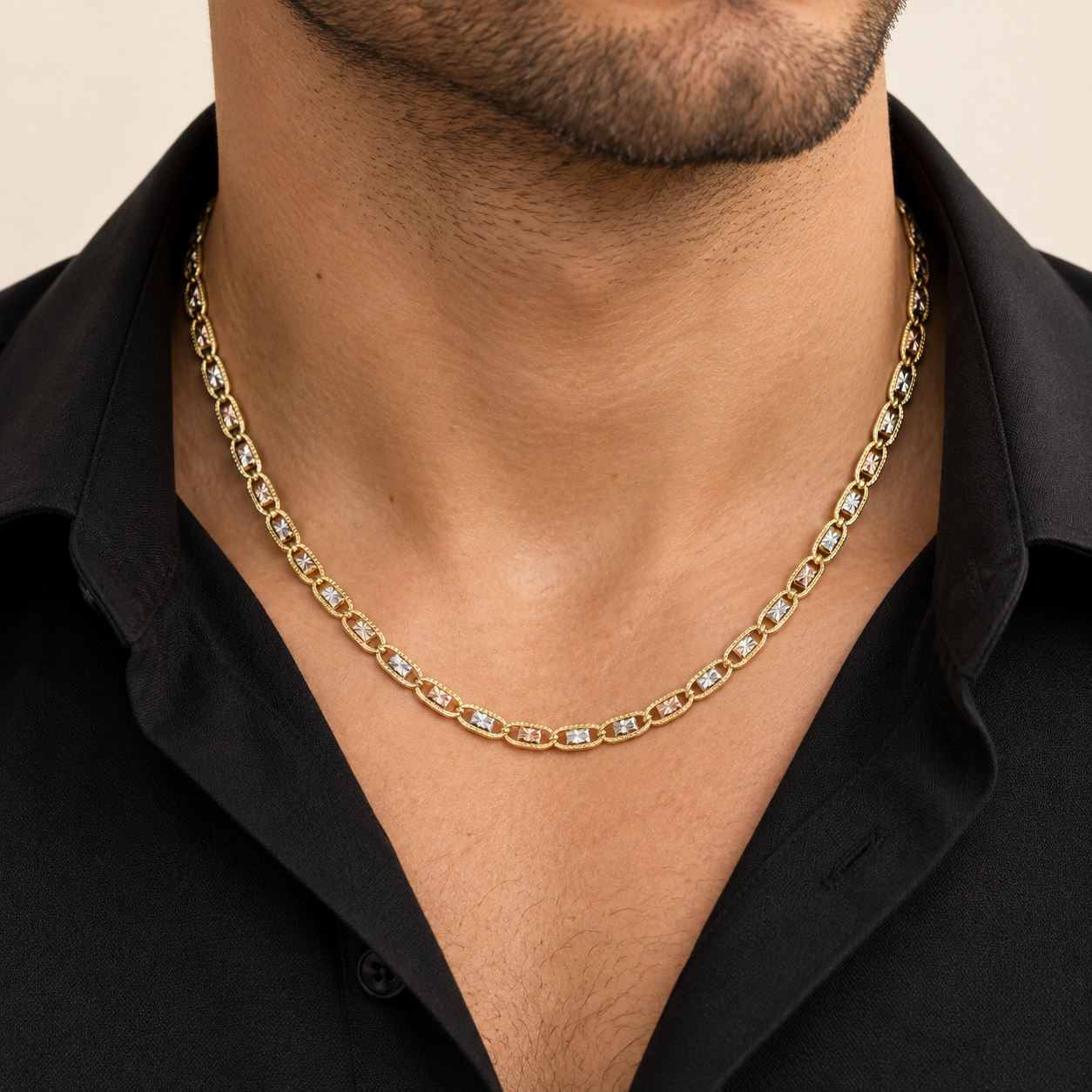     Male model wearing an 18-inch 14K solid tri-color gold diamond-cut Mariner chain with a black dress shirt.