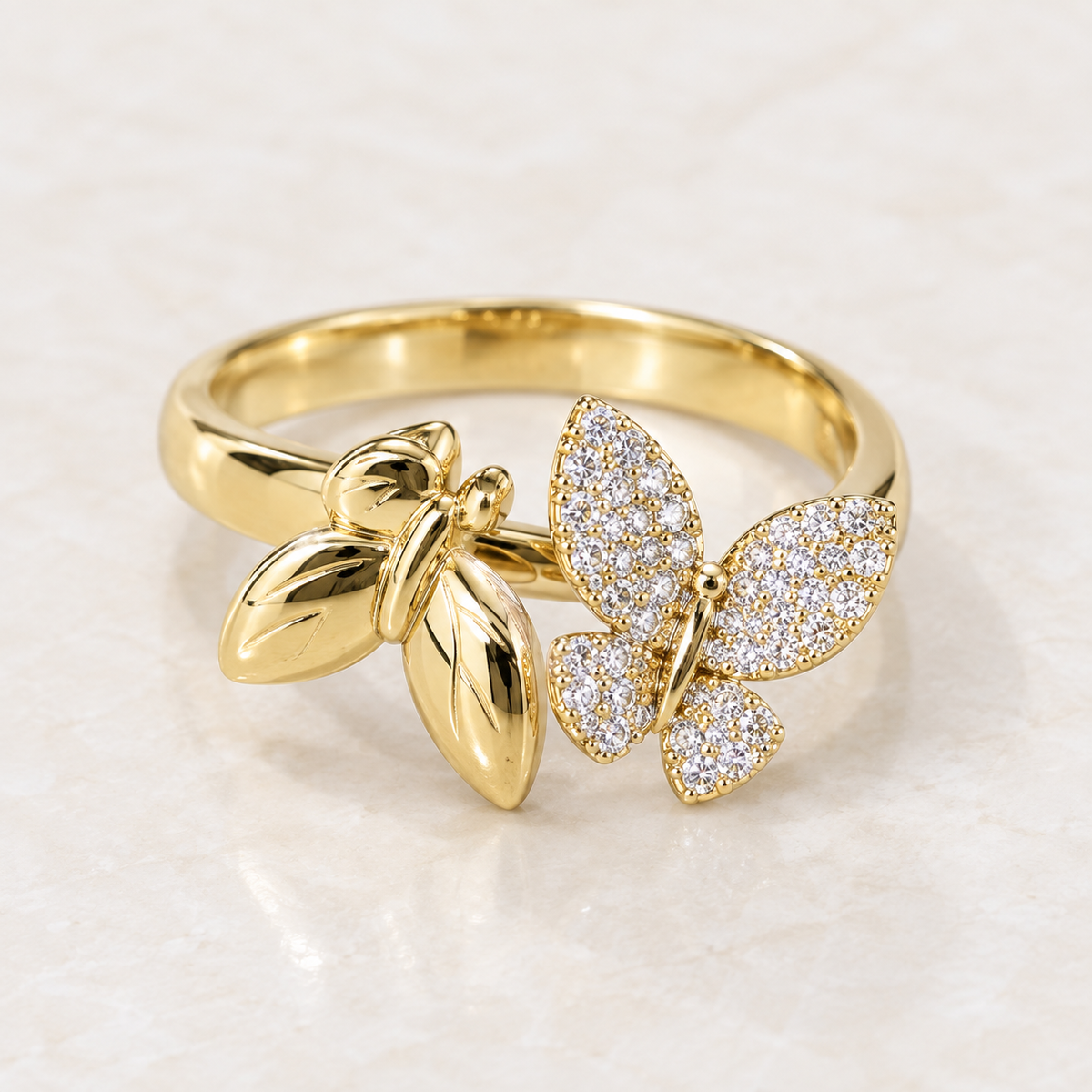     14K solid yellow gold two-butterfly bypass ring with clear cubic zirconias, front view.