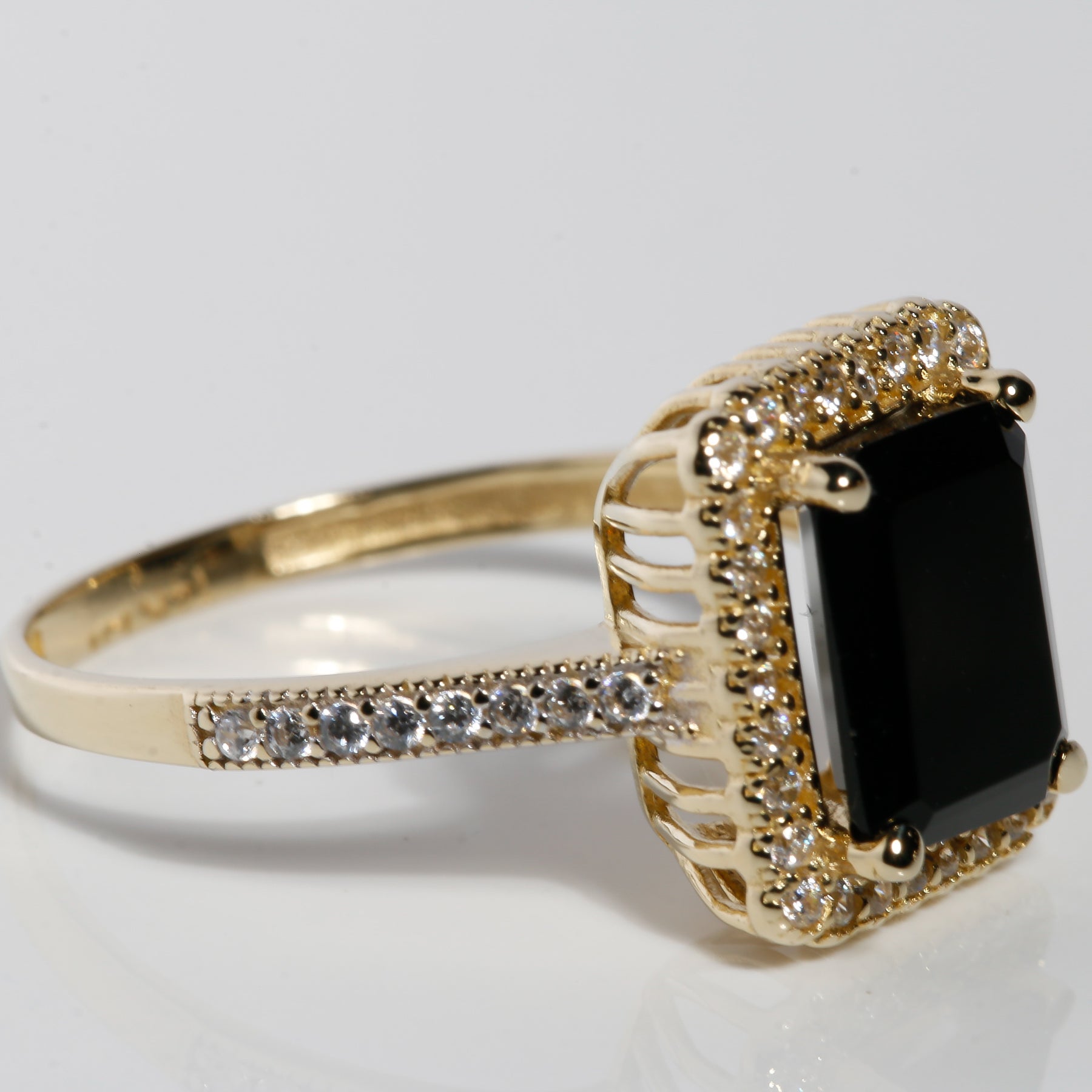 Side view of 14K solid gold black onyx ring with cubic zirconia halo setting