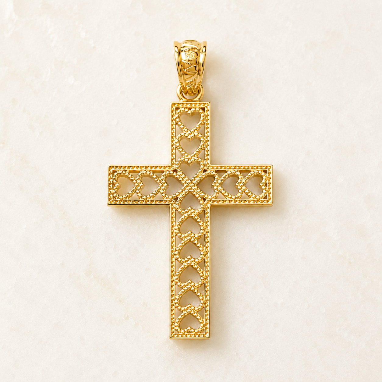 Close-up of the bail and top detail of a 14K yellow gold heart cross pendant with open heart cutouts.