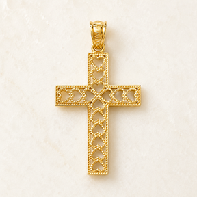 Close-up of the bail and top detail of a 14K yellow gold heart cross pendant with open heart cutouts.